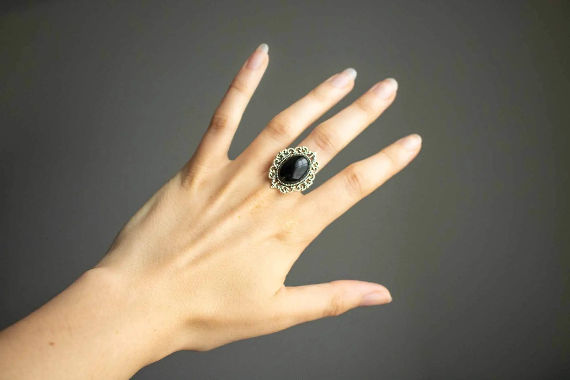 Bague en Onyx noire Hécate posée sur une main avec un design élégant et intemporel